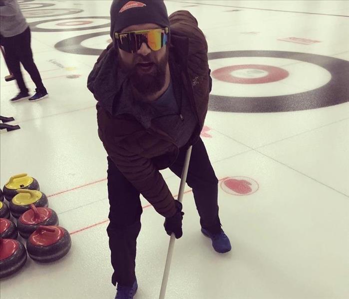 Luke curling at the 32nd annual IBADR Curling Bonspeil