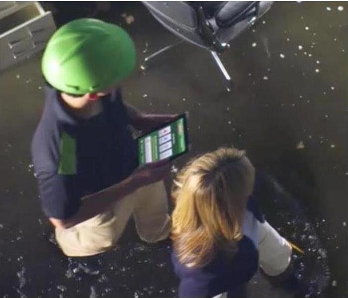 Picture of SERVPRO technicians using the SERVPRO app
